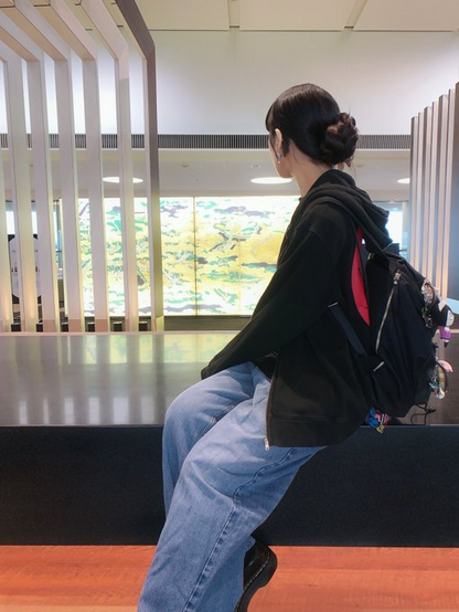 Himari seated at an airport