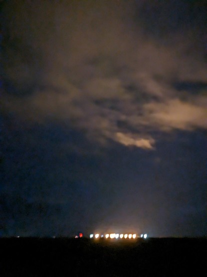 Lights in the clouds reflecting bright lights at a sugar beet staging area in rural Minnesota.