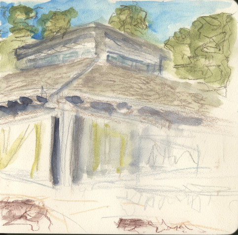 A colored pencil and wash sketch of the rear corner of a one-story building with a sloping capped by an extension for skylights. There are tall trees behind the building.