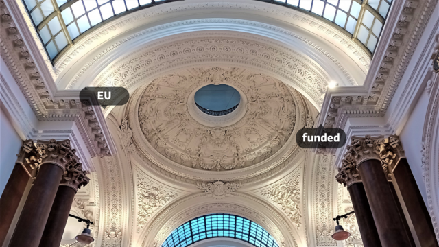 A photograph of the stuccoed ceiling inside the Brussels Stock Exchange.