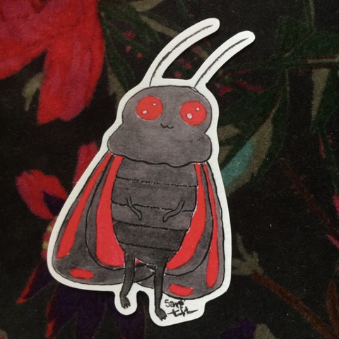 A sticker of a cinnabar Mothman. He’s got big red eyes and a fluffy black body, with long antennae and red and black wings.