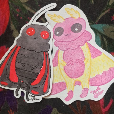 Cinnabar Mothman and his boyfriend, Rosy Maple Mothman, who is a fluffy fellow in shades of yellow and pink.