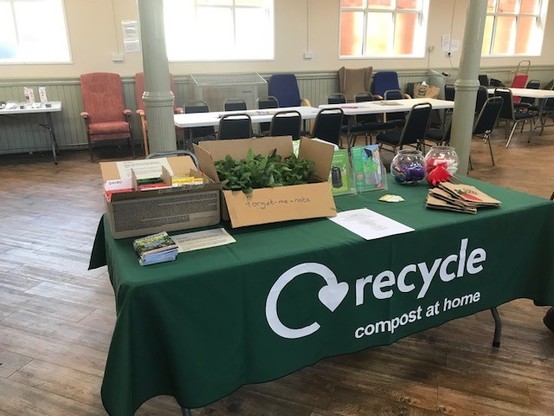 Our stall at Nuneaton Big Save event with a "Recycle Compost at Home" table cloth, boxes of free seeds and plants that were given away and composting information.