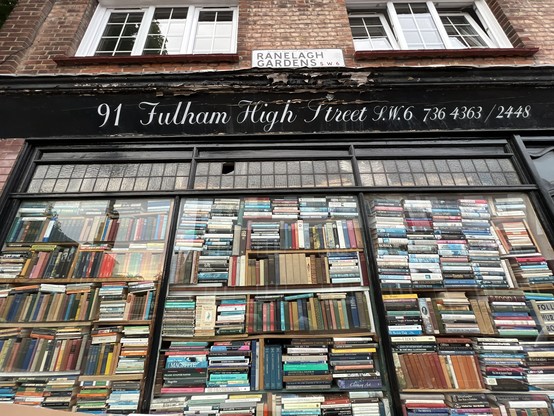 Book shop Putney Bridge, London. 
Books lined up blocking the front window, which is used as a book shelf.