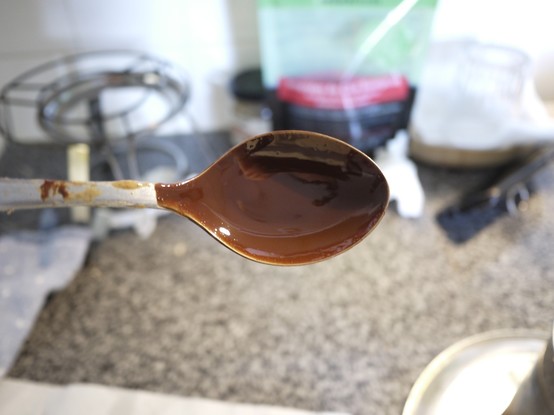 Spoon dipped in liquid chocolate