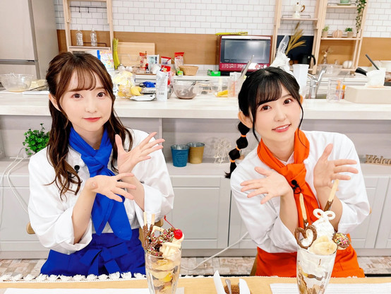Tanaka Minami and Koharu Riko in a shief outfit showing off their creations.