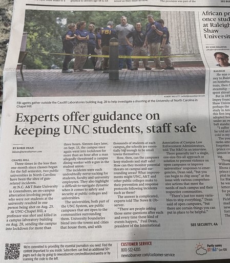 A photo of a newspaper article with the headline â€œExperts offer guidance on keeping UNC students, staff safe.â€�