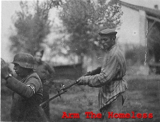 image/jpeg of a concentration camp prisoner marching a german soldier at gunpoint. Captioned: Arm The Homeless
