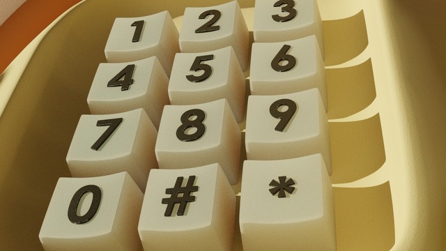 Extreme closeup of the number pad on the phone. The buttons look a little bit soft and very slightly translucent, with raised, black numbers in Century Gothic.