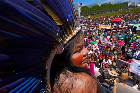 Brazil’s Indigenous peoples minister, Sônia Guajajara, speaks from the top of a sound car at a march in Brasília. Photograph: Eraldo Peres/AP
