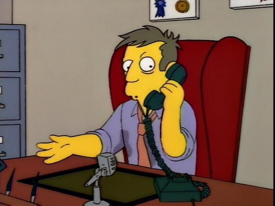 A nervous, sweating Principal Skinner sits behind his desk, holding a phone.