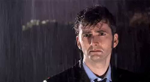 Doctor who, sad looking at the camera under the flooding rain