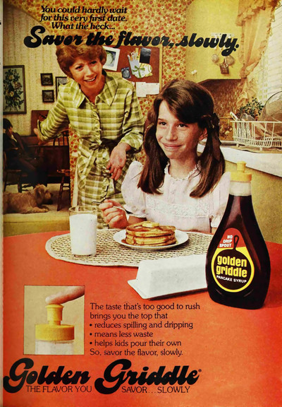 Young girl savors her pancakes while her mom points out that her date has been waiting for her in the other room.