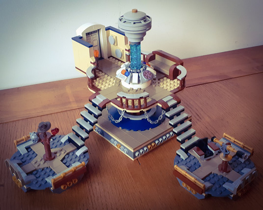 An overhead shot of my TARDIS Console MOC, showing the full console area, with a brown leather sofa, wooden banister rails and round things!