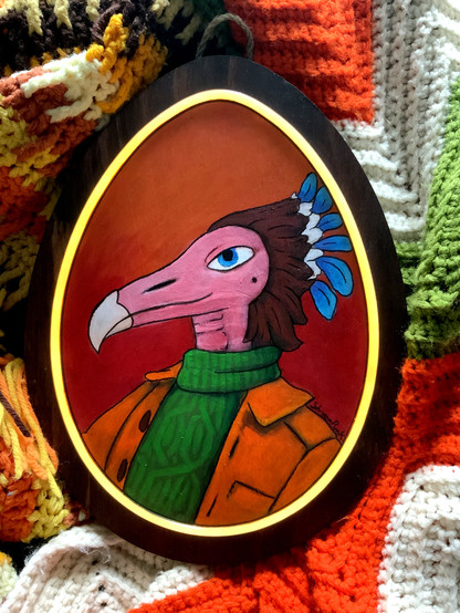 Acrylic painting on an egg-shaped piece of wood, with a glowing yellow inset framing the portrait. The portrait is of a species called a fetroscale, which in this example is a raptor-like bird with a featherless face, primarily brown feathers on the back of their head, and a fancy blue feather plume. They are wearing a green turtleneck and brown leather jacket.