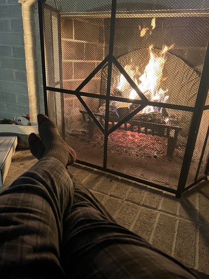 Photo of my feet up by a fire in the fireplace