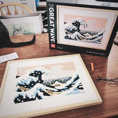A box for a new LEGO kit next to that completed kit showing Hokusai's famous painting, The Great Wave Off Kanagawa.