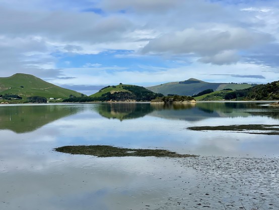 Hills reflect in inlet waters