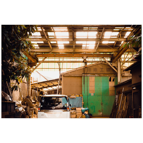 Warm sunlight filters through the transparent garage roof. It illuminates various ladders, winches, and power tools with a welcoming mechanical glow of love.