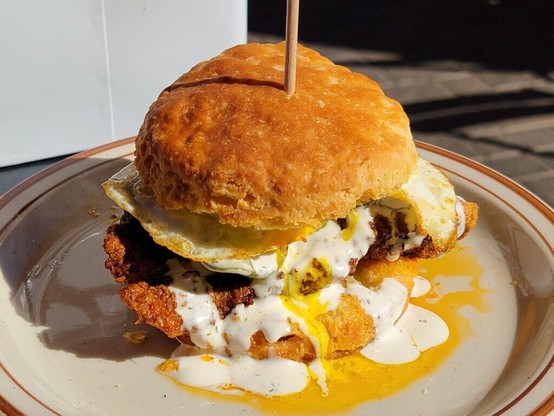 Nashville hot chicken, pickles, ranch, and a fried egg on a buttery biscuit.