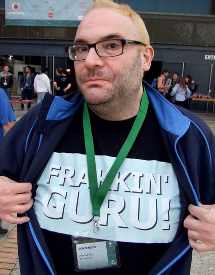 conference curator: photograph of a conference attendee holding his jacket open to reveal a t-shirt with the words "FRAKKIN' GURU!". Photo attribution: Flickr user elgris