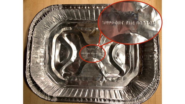Photograph of an aluminum foil baking dish with the words "SUPPORT THE BOTTOM" embossed at its center.
