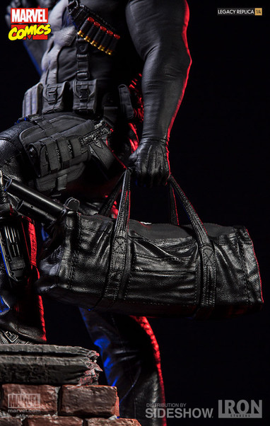 close-up of his hand gripping handles of duffel bag