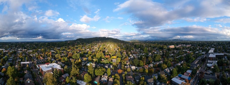 Light from the sunset shines on the neighborhood on the west side of Mt Tabor. There are clouds in the sky from a recent atmospheric river. This is a brief break in the rain.