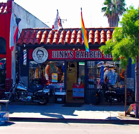 Shot of Dinks Babershop with motorcycles parked in front