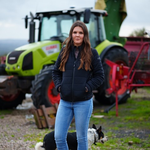 Helen Drinkall, a livestock farmer from Chorley, Lancashire, in front of a tractor.