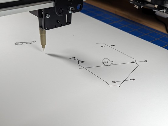 A pen plotter robot drawing some lines that might resemble some exploded parts of a Power Mac G4 tower maybe.