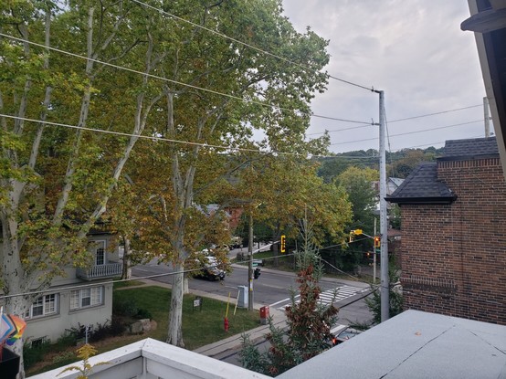 Street view in Kirkendall, Hamilton, Ontario - forested part of Niagara Escarpment visible in background