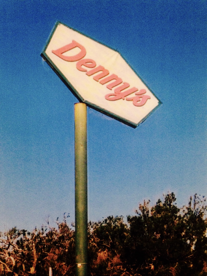 A crooked sign outside a hurricane-demolished  Dennyâ€™s restaurant, 2006