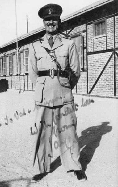 Photo of Maskelyne in British Army uniform standing in front of barracks.