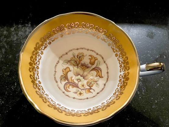 Top-down view of tea in an Elizabethan Staffordshire tea cup.