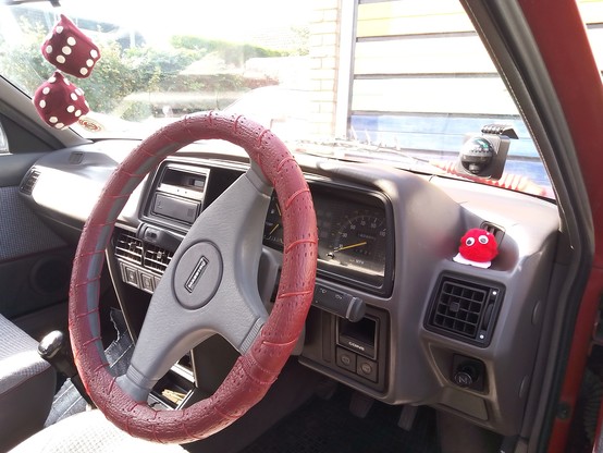 The interior of an Austin Maestro sporting an assortment of 90s automotive accessories.