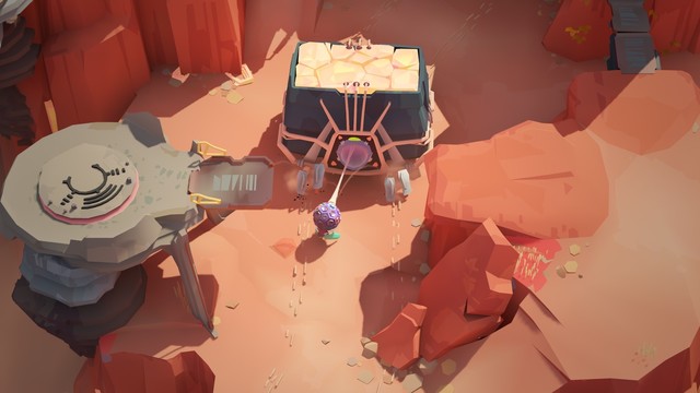 Capture d’écran du jeu-vidéo Cocoon, le petit personnage ailé est en train de tracter ce qui s’apparente à un animal de type rocheux, il le fait avancer pour que celui-ci lui serve de pont pour rejoindre un endroit en hauteur.
La zone dans laquelle se passe l’action est désertique et rocheuse.