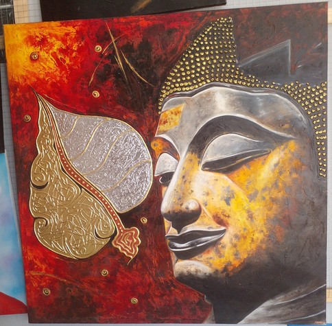 a painting of the Buddha's head, his eyes closed in meditation next to him is a banyon tree leaf, half painted in gold, half in silver, with designs all over them, they are against an orange. red, and black background