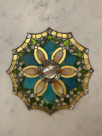 A close up detail of a mosaic flower in marble.