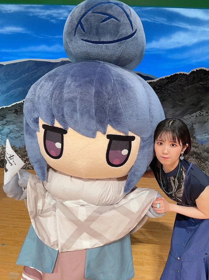 Nao stands to a life size plushie version of Rin.