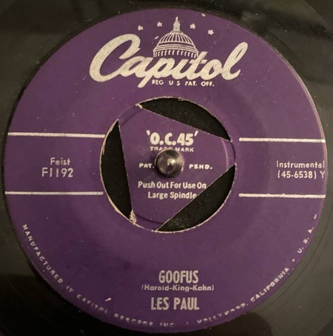 Purple Capitol label on a 45rpm single with a triangle insert with Goofus Les Paul at the bottom of the label.