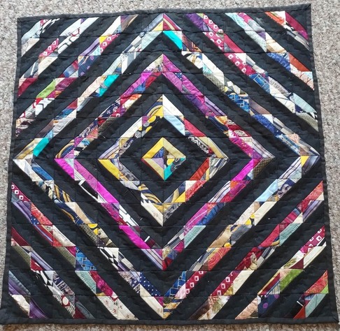 painting of a quilt, the blocks of it make a diamond design, a lot of purple, black and red colors, white also