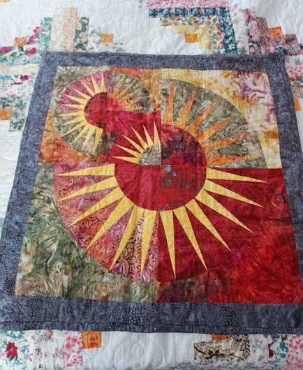 a solar-themed quilt, lots of Indonesian / South Pacific energy in it