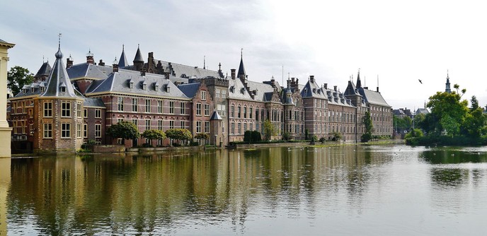 photograph of large palace-like building alongside a manmade body of water