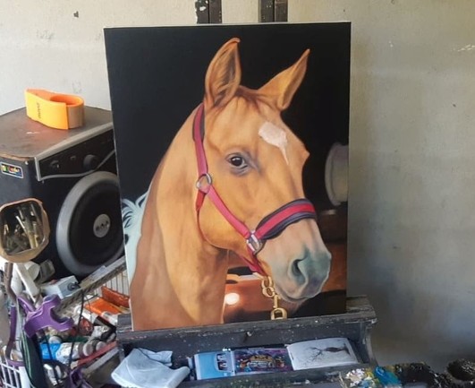 a photo of the painting taken from further away, up on the easel