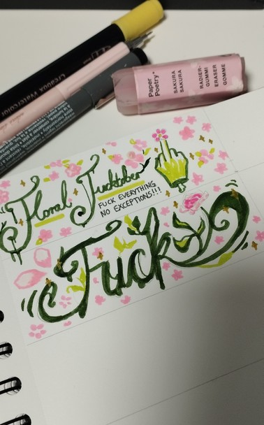 Sketchbook page divided in small sections of which two are filled. Top section says "Floral Fucktober", HS a green middle finger and a small text saying "Fuck everything, no exceptions!!!". Second section just says fuck. All letters are cursive and written in dark green and the rest of the space is filled with pink petals and other smaller floral elements.