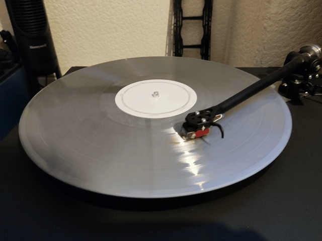 A silver LP rotates
