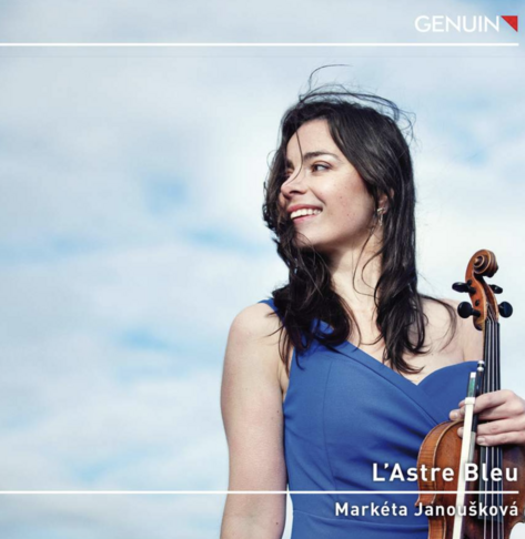 Markéta Janoušková standing with the blue sky behind her. She has long dark hair and is wearing a blue dress, holding the violin to her left while looking to the right. (her right)