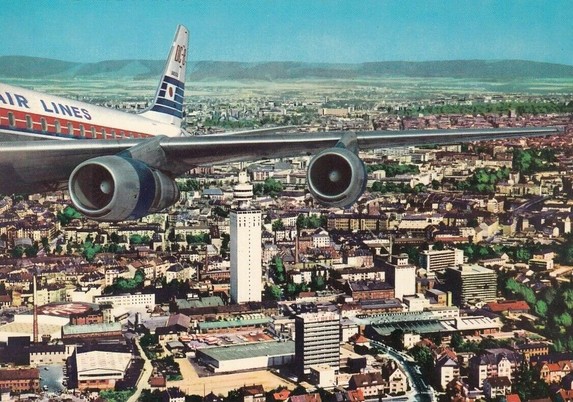 Really strange picture. So they cut out a picture of just the dc-8's uper right fussalage, tail, wing with engins and pasted it over a birds eye view of Frankfurt.