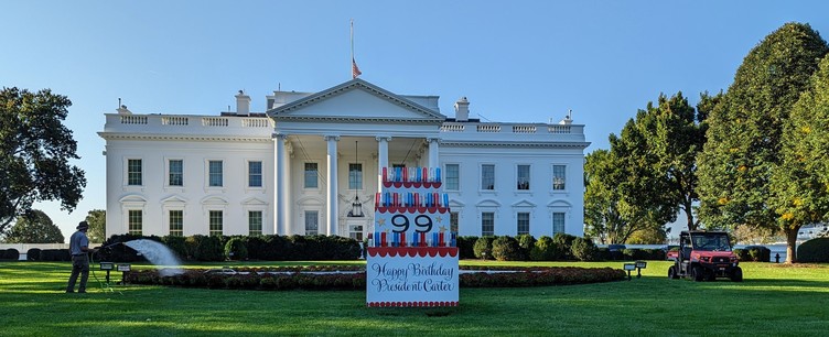 2 October 2023 North lawn of the White House, a sign that looks like a cake with candles and the number 99. Reads РђюHappy Birthday President CarterРђЮ